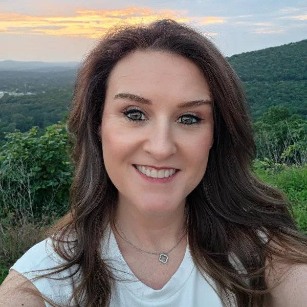 Dr. Rene' smiling outdoors at sunset